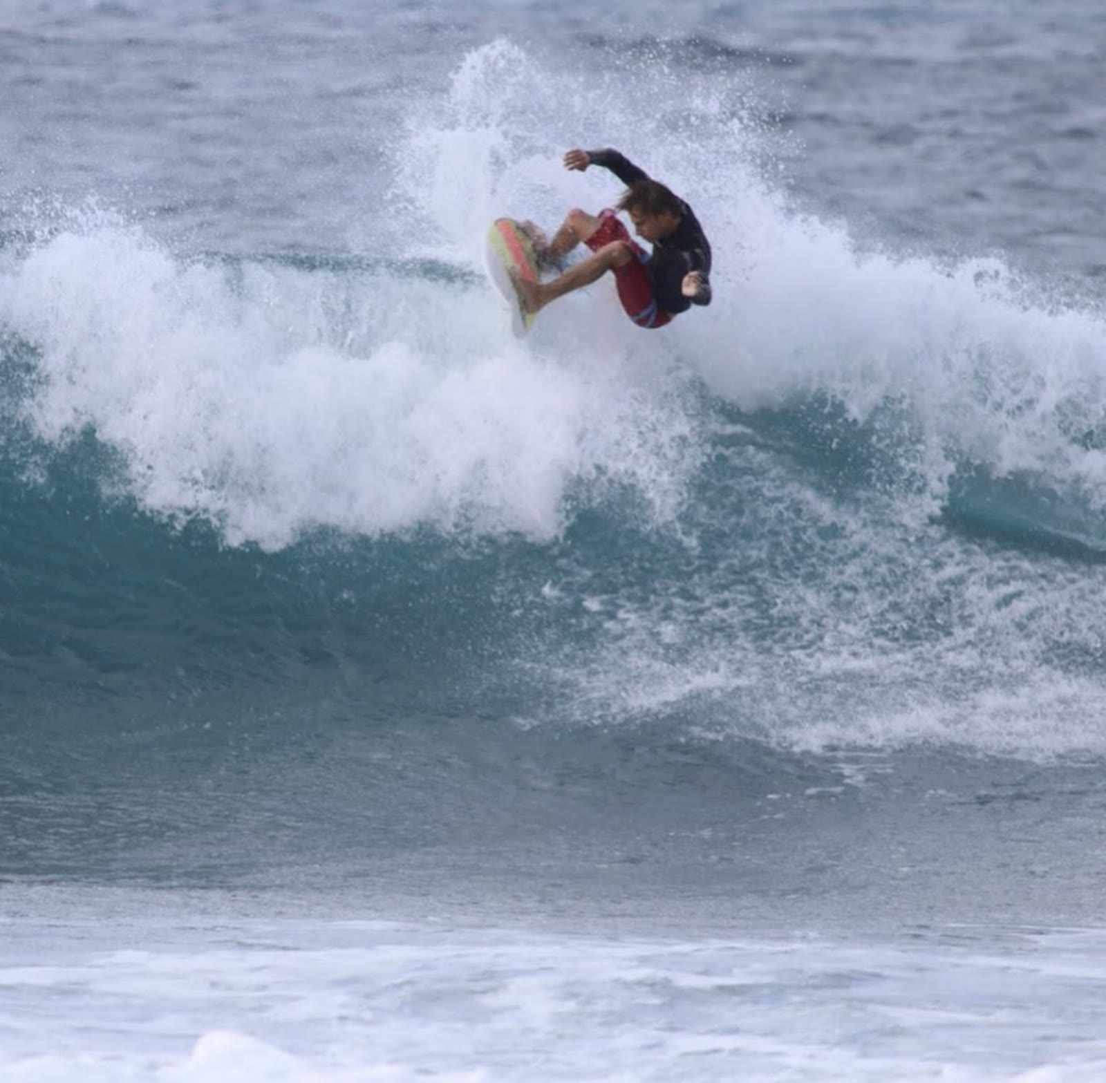 Surfer launching an air off the lip