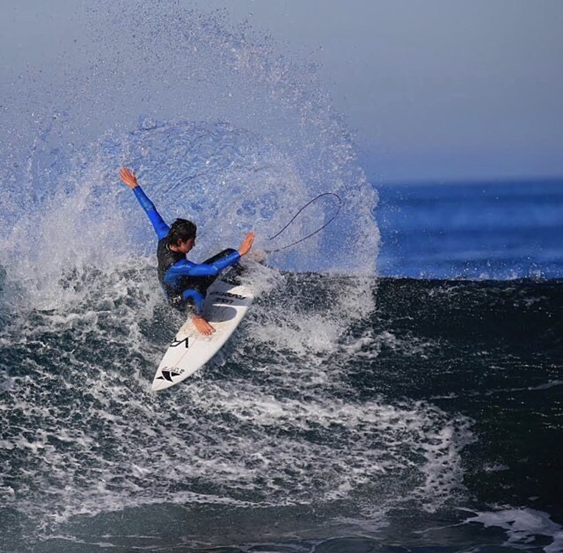 Advanced surfer throwing a big spray off the top