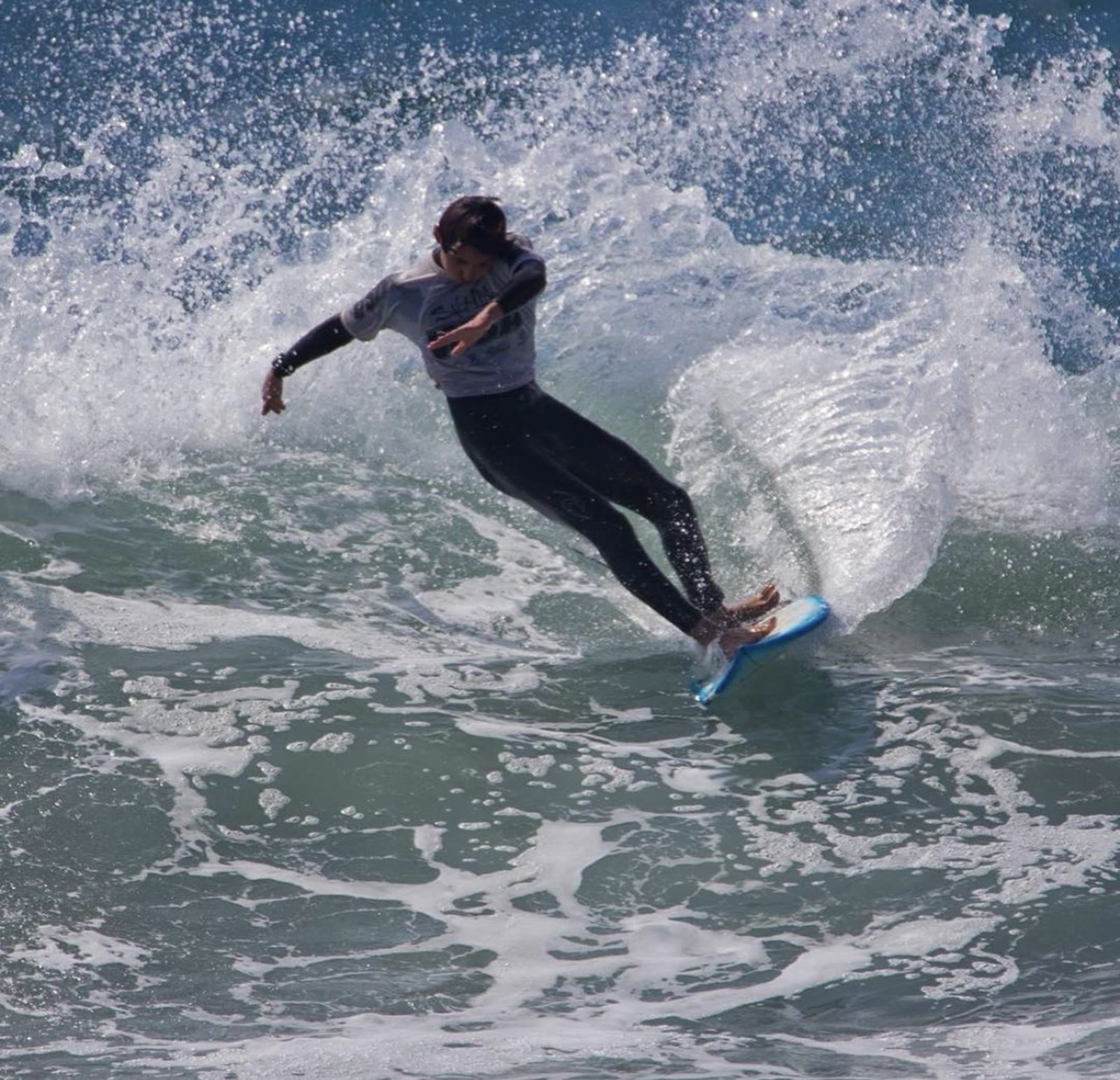 Surfer turning off the top with spray