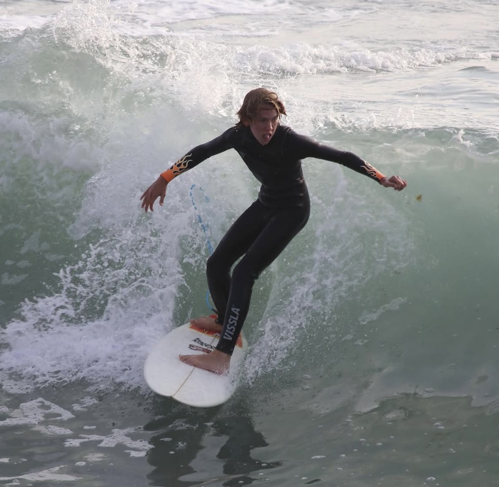 Surfer riding across a wave
